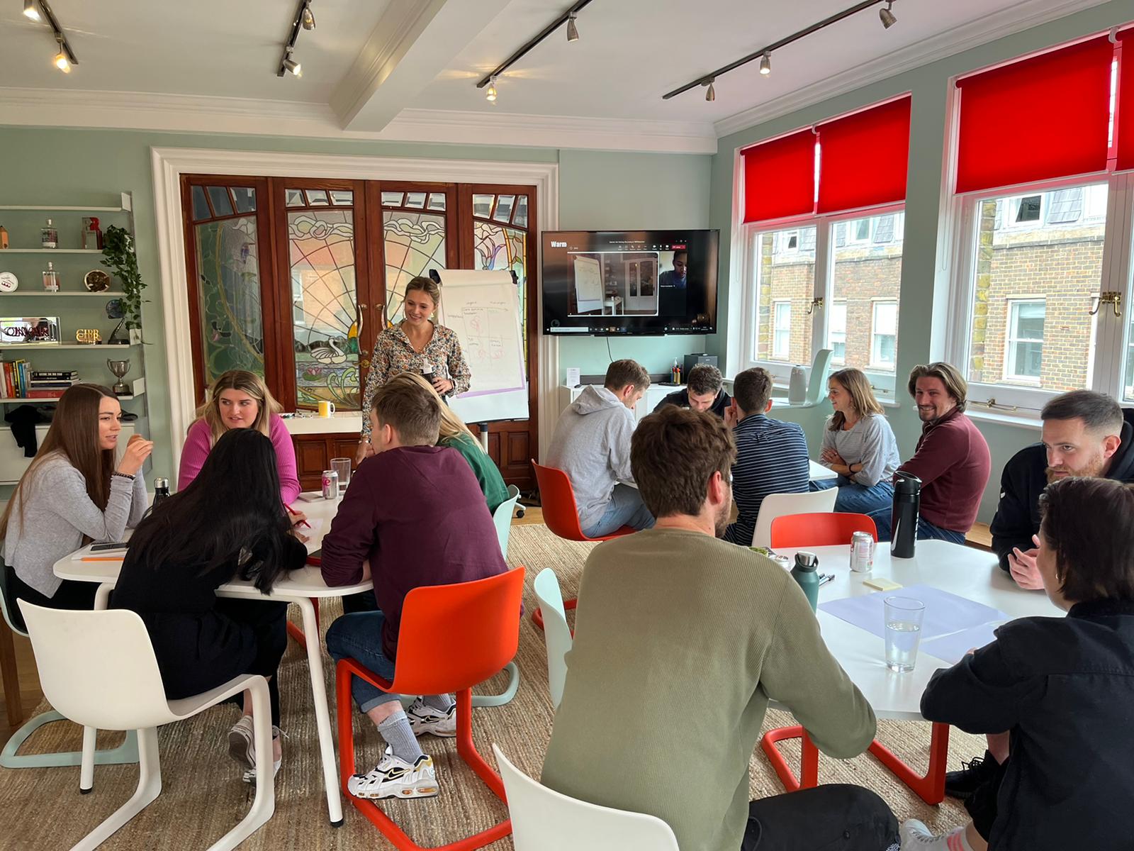 A team workshop in small groups around tables